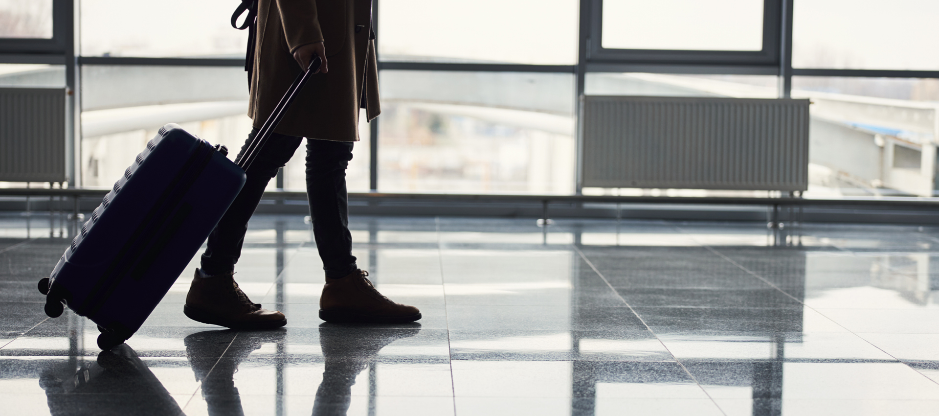Viaggiatore in aeroporto con valigia